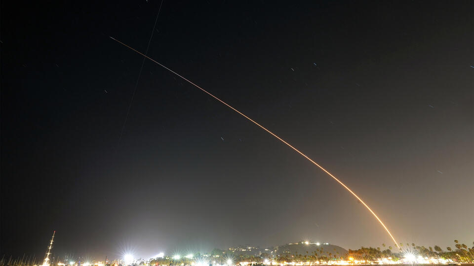 A time-lapse photo showing the arc of a rocket launch